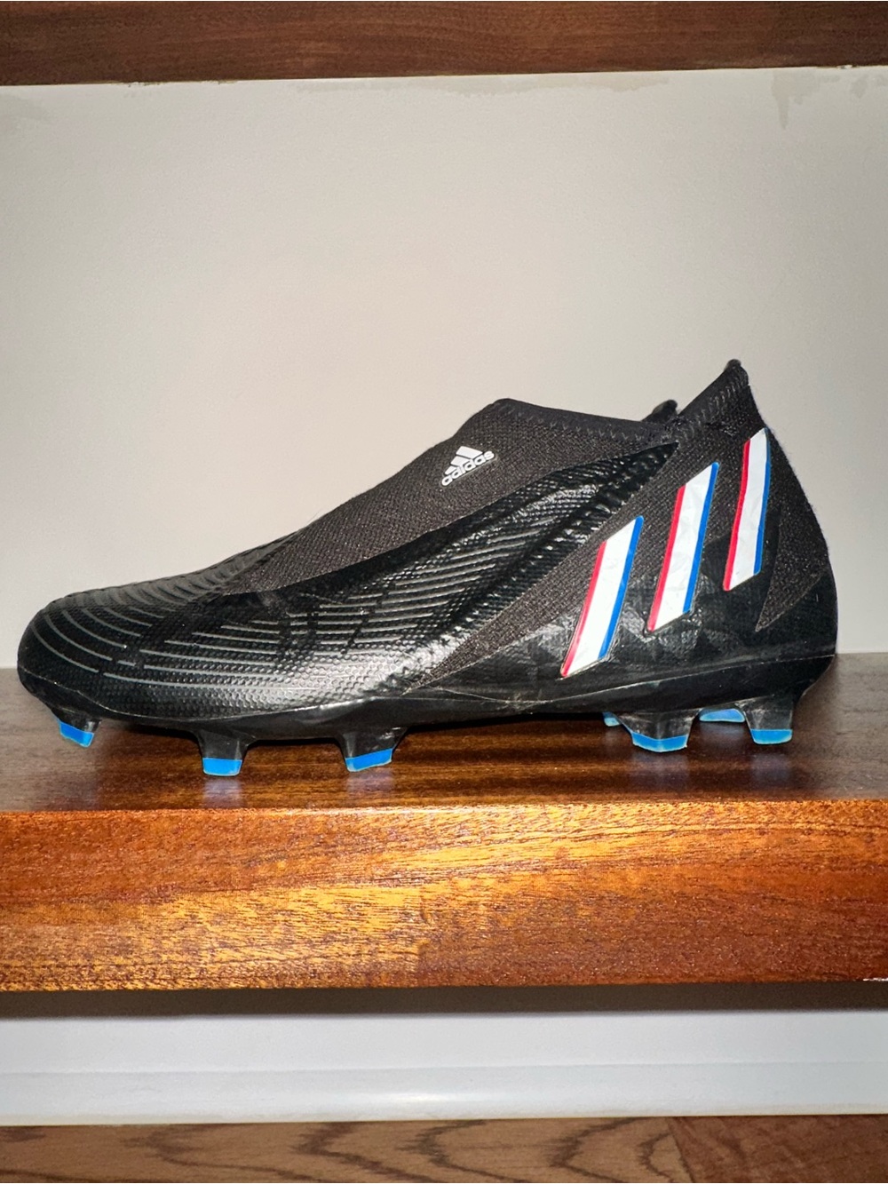 adidas Black Soccer Cleat with Blue and Red Stripe Accents